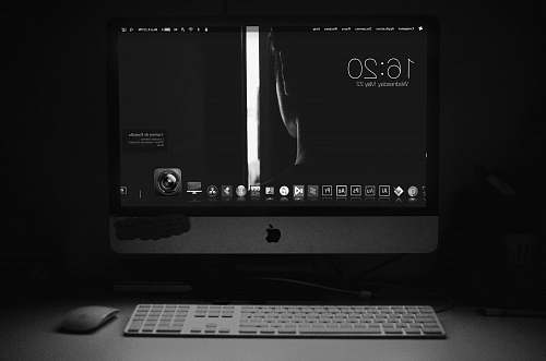 computer hardware silver iMac turned on beside Apple Magic Keyboard and Magic Mouse computer keyboard